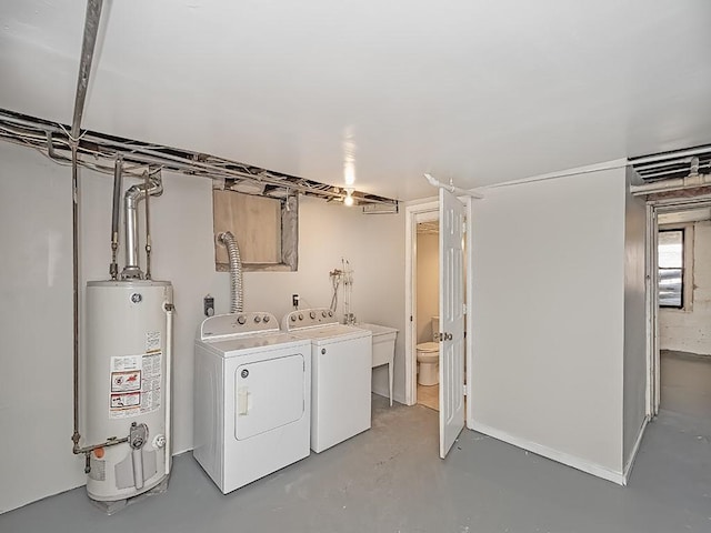 washroom featuring washer and dryer, gas water heater, and laundry area