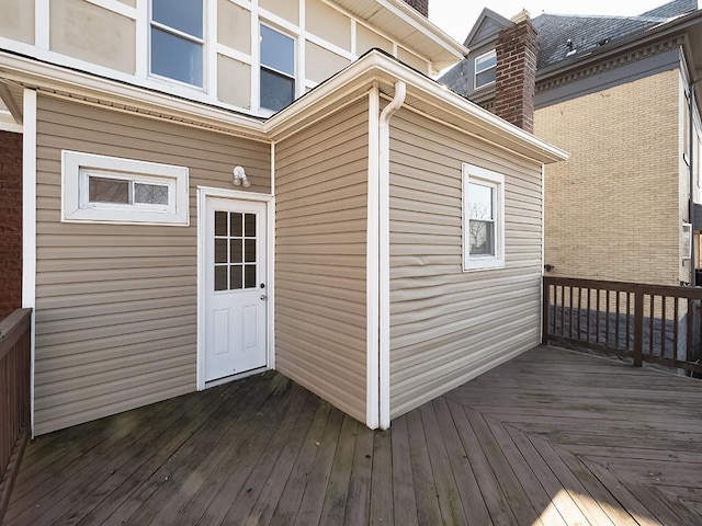 view of exterior entry with a deck