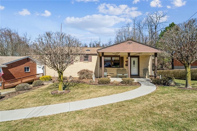 view of front of property featuring a front lawn, a porch, and brick siding