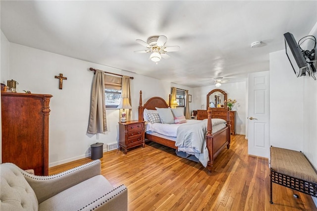 bedroom with a ceiling fan, baseboards, visible vents, and light wood-type flooring