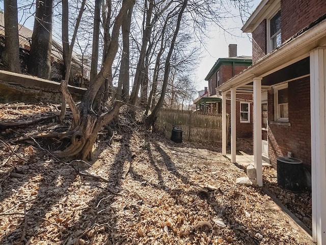 view of yard featuring central air condition unit and fence