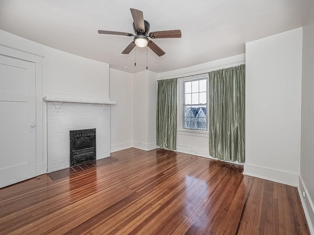 unfurnished living room featuring a fireplace, baseboards, ceiling fan, and wood-type flooring