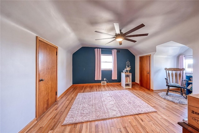 bonus room with visible vents, baseboards, vaulted ceiling, light wood-style flooring, and a ceiling fan