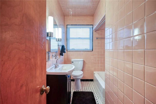 full bathroom with vanity, tile walls, toilet, and tile patterned floors