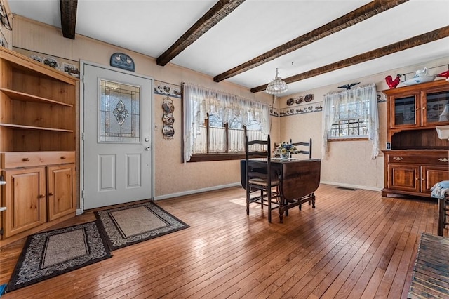 entryway featuring baseboards, wood-type flooring, and beam ceiling