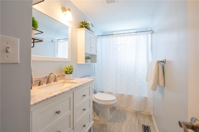 bathroom featuring vanity, shower / bath combination with curtain, toilet, and visible vents