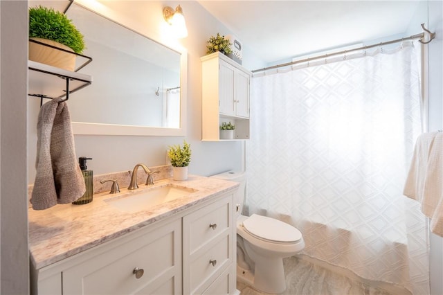 full bath with vanity, shower / tub combo, and toilet