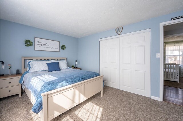 bedroom featuring a closet, carpet flooring, and a textured ceiling