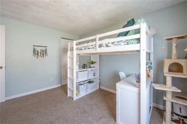 bedroom with baseboards, a textured ceiling, and carpet flooring