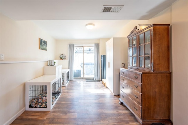 interior space featuring visible vents and dark wood-style flooring