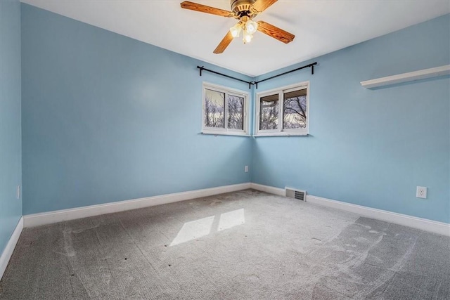 unfurnished room featuring visible vents, carpet flooring, baseboards, and ceiling fan