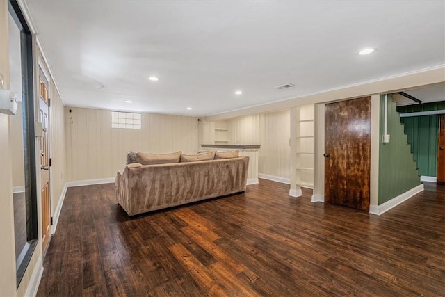 living room with stairway, baseboards, and dark wood-style flooring