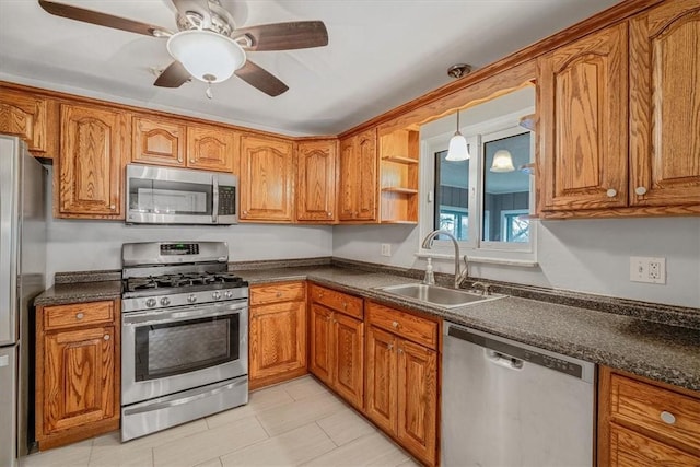 kitchen featuring brown cabinets, stainless steel appliances, and a sink