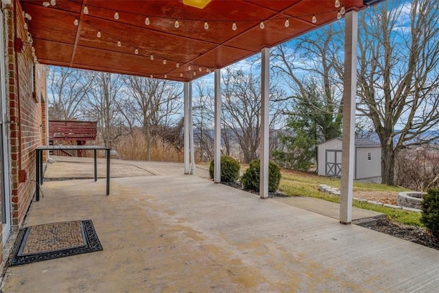 view of patio featuring an outbuilding and a shed