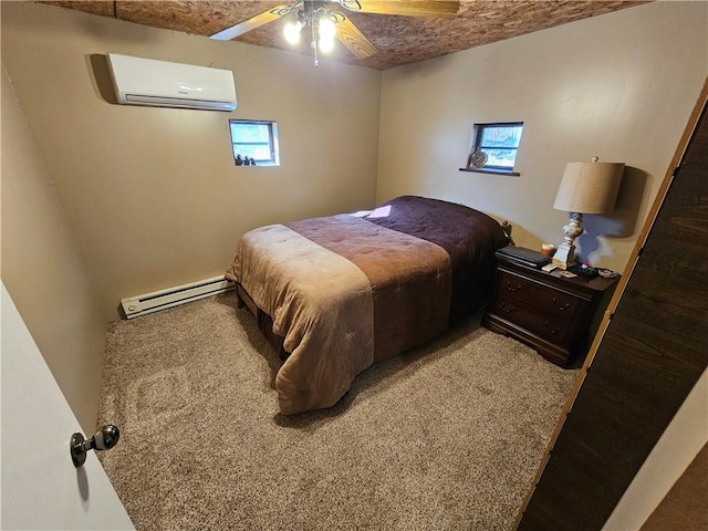 bedroom with a baseboard radiator, ceiling fan, and a wall mounted AC