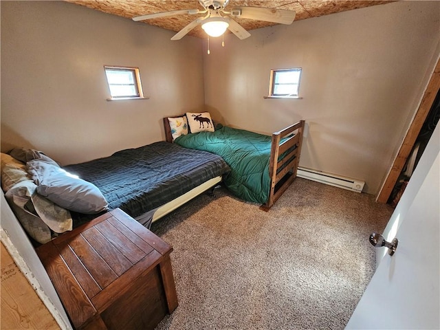 bedroom featuring a ceiling fan, multiple windows, carpet, and baseboard heating