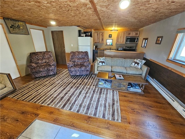 living area featuring brick ceiling, a baseboard radiator, and wood finished floors