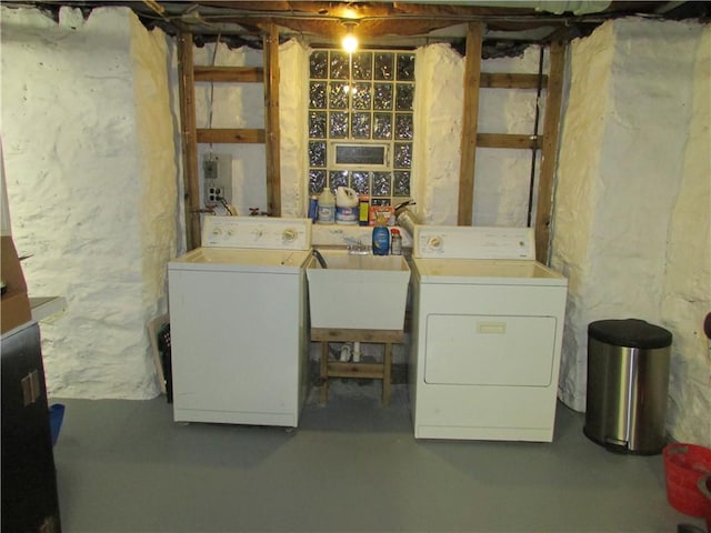 washroom with a sink, laundry area, and washing machine and clothes dryer