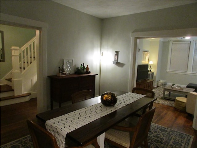 dining area featuring stairway and wood finished floors