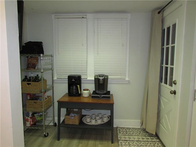 doorway to outside with wood finished floors and baseboards