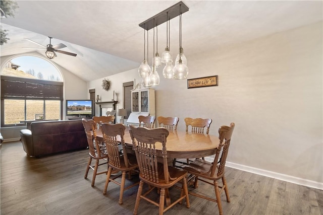 dining space with ceiling fan, baseboards, lofted ceiling, and wood finished floors