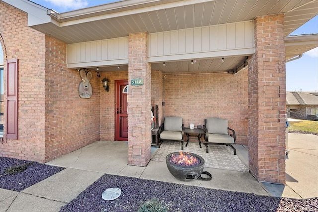 view of exterior entry with a patio