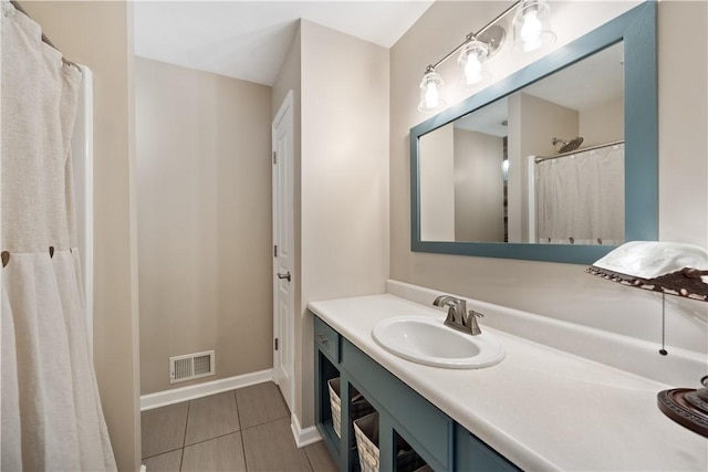 full bathroom featuring tile patterned floors, visible vents, baseboards, and vanity