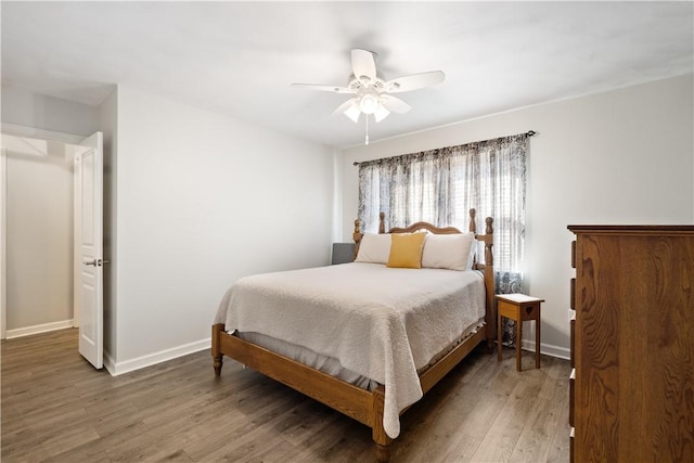 bedroom featuring a ceiling fan, wood finished floors, and baseboards