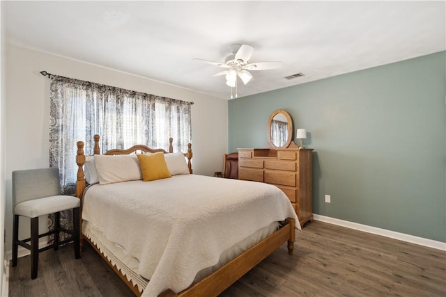 bedroom featuring visible vents, ceiling fan, baseboards, and wood finished floors