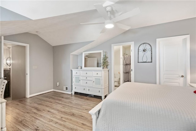 bedroom with visible vents, a ceiling fan, wood finished floors, baseboards, and vaulted ceiling