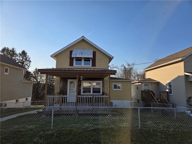 view of front of house featuring a porch, fence private yard, and a front yard