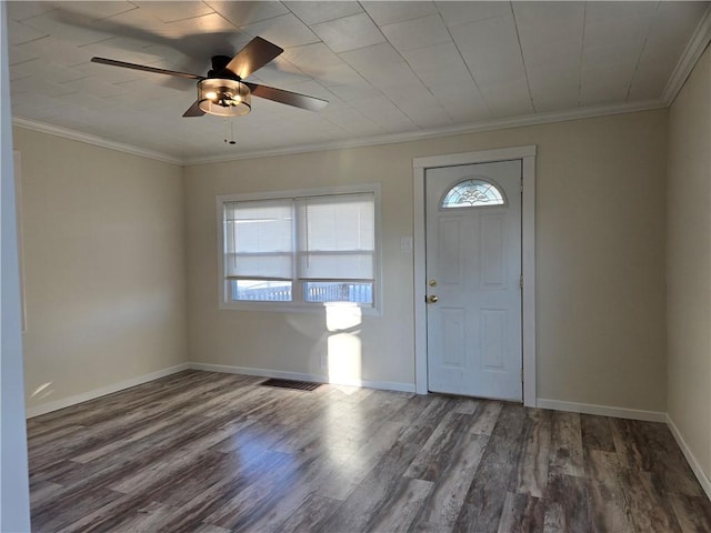 foyer featuring crown molding, wood finished floors, baseboards, and a wealth of natural light