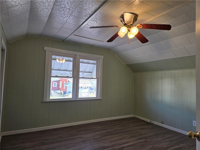 bonus room with a ceiling fan, lofted ceiling, dark wood-style floors, and baseboards