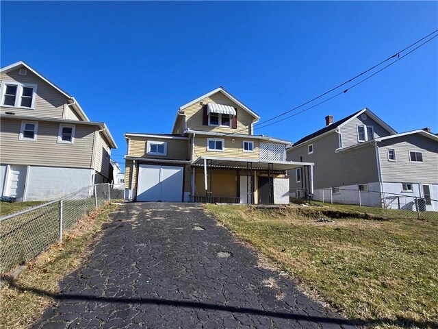 view of front of home with a front lawn, aphalt driveway, a porch, fence, and a garage