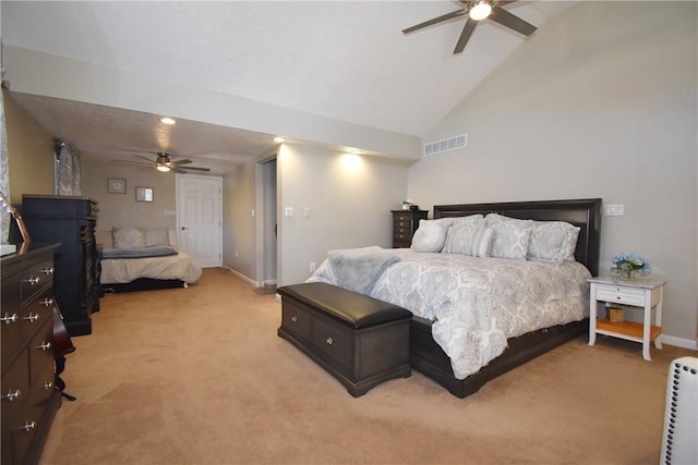 bedroom with visible vents, baseboards, light colored carpet, ceiling fan, and vaulted ceiling