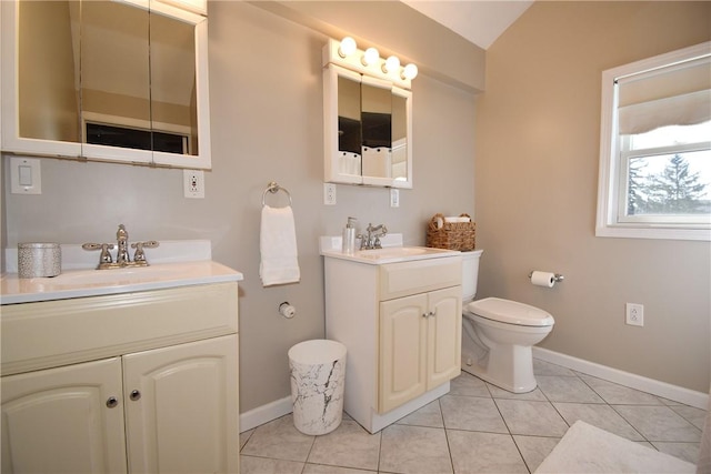 full bath featuring a sink, toilet, two vanities, and tile patterned flooring