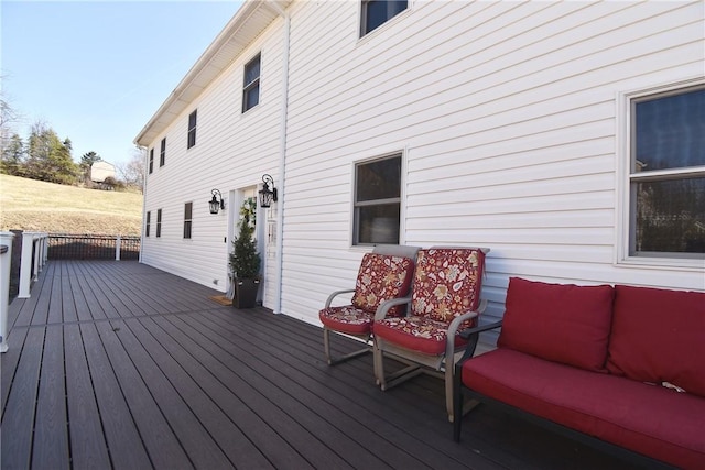 wooden terrace with an outdoor living space