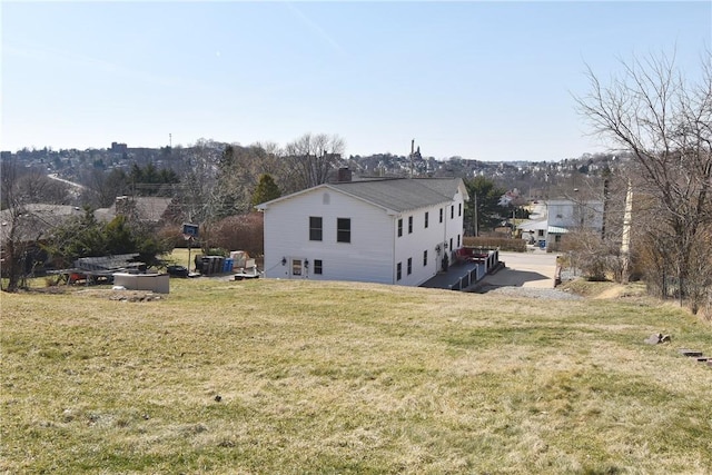 rear view of property featuring a lawn