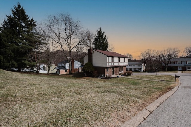 property exterior at dusk with a yard