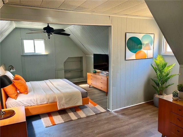 bedroom with lofted ceiling and wood finished floors