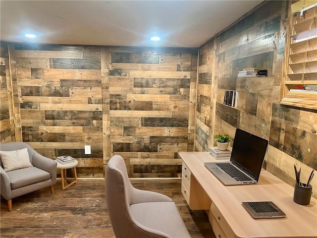 office with wooden walls and dark wood finished floors