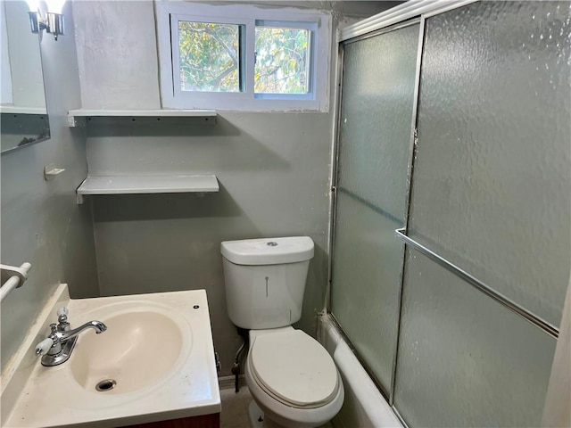 full bathroom with vanity, toilet, and a shower with shower door