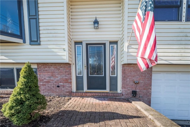 entrance to property featuring brick siding