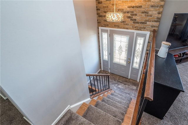 foyer entrance with stairway, baseboards, and wood finished floors