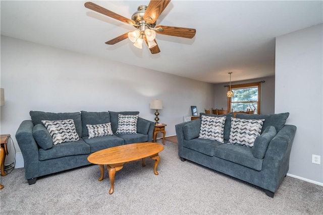 living room featuring baseboards, carpet, and ceiling fan