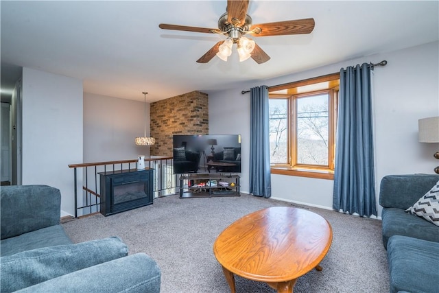 living area featuring baseboards, carpet, and ceiling fan