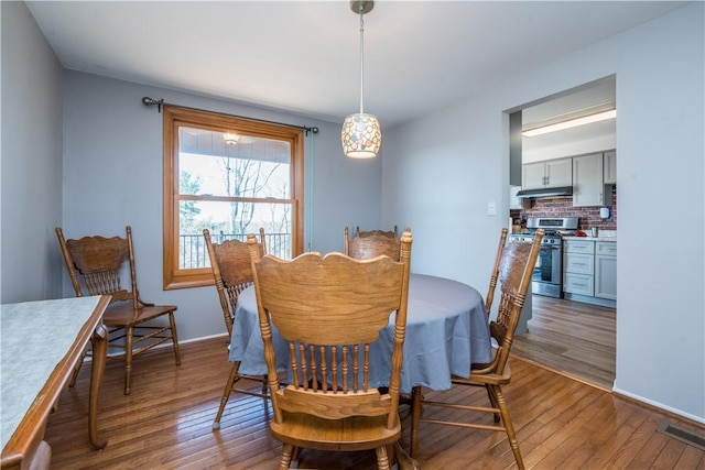 dining space featuring dark wood finished floors and visible vents