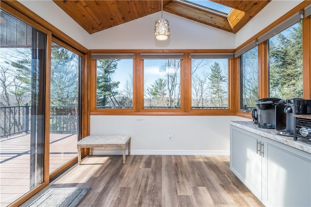 unfurnished sunroom featuring lofted ceiling with skylight and wood ceiling