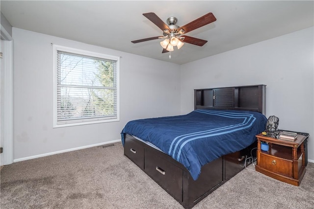 carpeted bedroom featuring a ceiling fan and baseboards