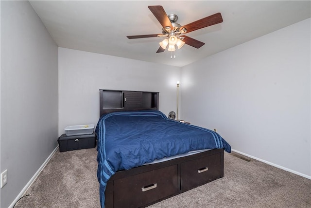 carpeted bedroom featuring a ceiling fan, visible vents, and baseboards